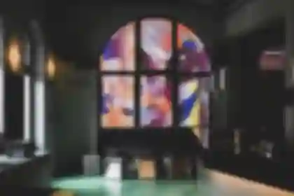 Large-format window art using backlit film, featuring an illuminated, abstract pixel-pattern design for Nuremberg's Blok bar.