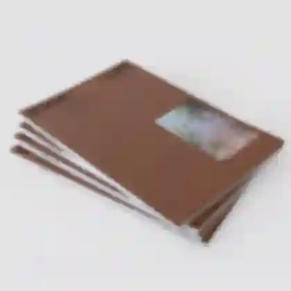 Stack of artist catalogues titled GOOD LIFE for photographer Meike Männel, showcasing the cover design and open-thread binding.