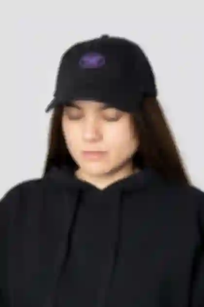 Black baseball cap showcasing the purple embroidered 'GOOD LIFE' logo design for Meike Männel.