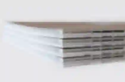 Stack of artist catalogues titled GOOD LIFE for photographer Meike Männel, showcasing the open-thread binding.